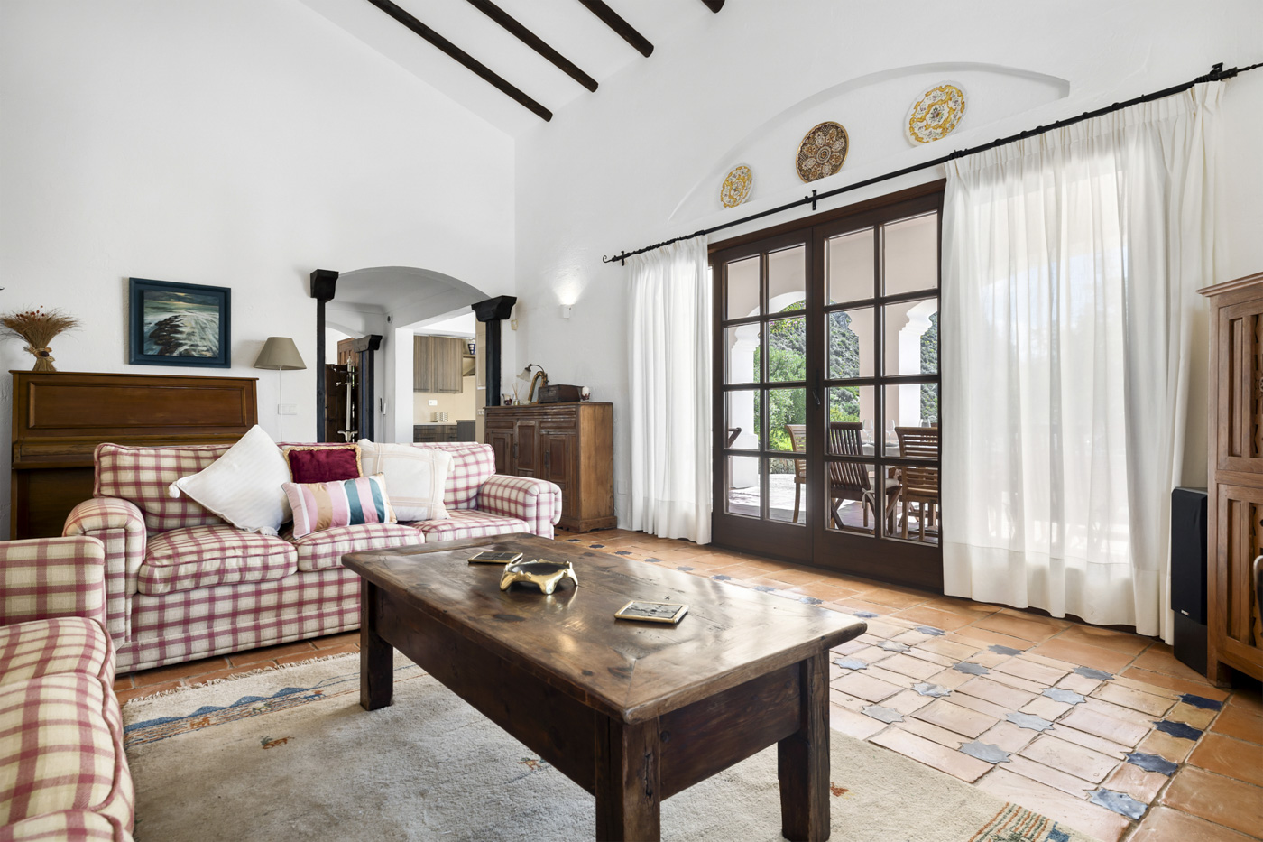 Living room with doors opening to furnished terrace